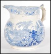 A 19th century Staffordshire Pearlware jug having a scrolled shaped handle with a blue and white