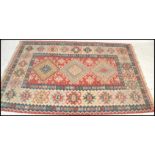 A vintage early 20th century decorative Kilim Persian / Islamic floor carpet rug having a muted