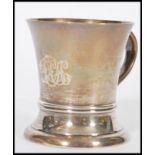 A hallmarked silver early 20th century tankard cup raised on a circular base with shaped handle. The