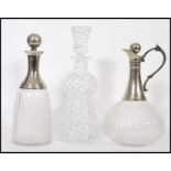 A pair of mid 20th century silver plate and cut glass decanters to include one bulbous form claret
