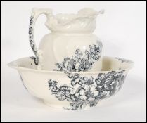 A Victorian ceramic washbowl and jug set in the ' Hollyhock ' pattern by S Bridgwood & Sons.