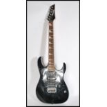 An Ibanez Gio Series six string electric guitar with black body serial number J031253885. Measures