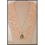 A string of  real pearls with a pink hue measuring approx 100 inches, along with a stamped 925