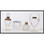 A selection of cut glass vanity dressing table items some having silver tops to include a small
