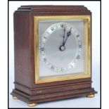 A vintage early 20th century Elliott mantel clock of square form having a silvered dial with Roman