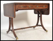 A George III early 19th century mahogany crossbanded drop leaf sofa table desk. Raised on reeded