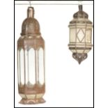 A pair of 20th century Morroccan lanterns /  lamps with inlaid glass panels, one having a pedestal