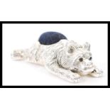 A stamped 925 silver pin cushion in the form of a bear having sapphire eyes, and a blue cushion to