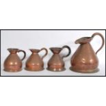 A group of four 19th century copper drinks measures liquid measures / jugs to include a City Of