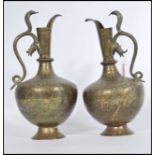 A pair of early 20th century Indian / Middle Eastern brass cobra snake water pourers ewer jugs