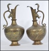 A pair of early 20th century Indian / Middle Eastern brass cobra snake water pourers ewer jugs