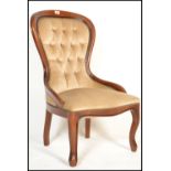 A 20th Century Victorian style spoon back mahogany framed button back upholstered nursing chair,