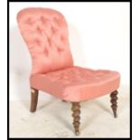 A 19th Century button backed mahogany  nursing chair having barley twist legs with brass casters,