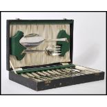 A cased set of silver plated cutlery consisting if twelve knives and forks with larger serving