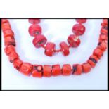 Two vintage large coral bead necklaces having graduating baroque coral beads with silver plated