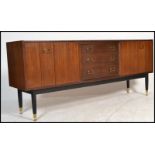 A vintage mid 20th Century G - Plan E Gomme Tola sideboard / credenza, twin bi - fold doors flanking