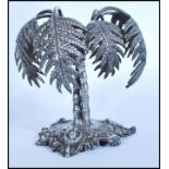 A 19th century Victorian silver plated centerpiece in the form of a palm tree raised on a scrolled