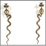 A pair of 20th century cast brass wall sconces in the form of hooded Cobra snakes having coiled