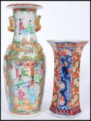 A 19th century Canton enamel vase having famille rose and verte decoration with white cartouche