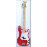 A vintage Marlin electric bass guitar having a red body with chrome tuning pegs. Measures 116cm long
