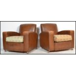 A pair of vintage 20th century Art Deco club armchairs having a faux leather type rexxine