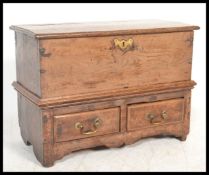 An 18th century country elm Welsh coffer bach. Raised on shaped ends with 2 short drawers over