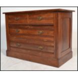 An Edwardian mahogany cottage chest of drawers being raised on a plinth base with 2 short over 2
