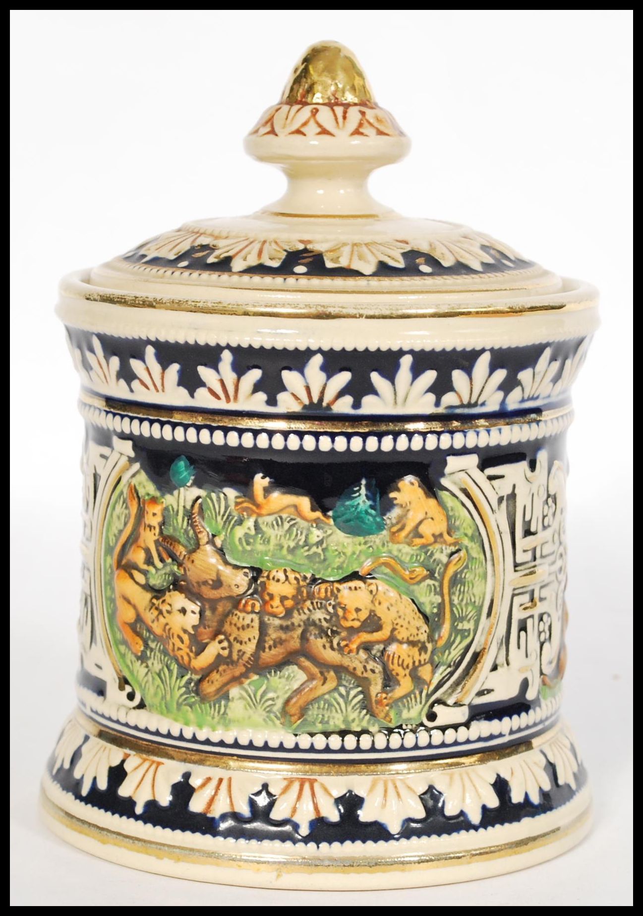 A vintage 20th century German stoneware tobacco jar humidor pot having relief scenes of lions and