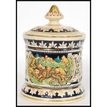 A vintage 20th century German stoneware tobacco jar humidor pot having relief scenes of lions and