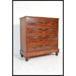 A late Victorian / Edwardian flame mahogany chest of drawers. Raised on a tall plinth base with