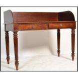 A large antique Victorian style mahogany writing table desk being raised on reeded turned and