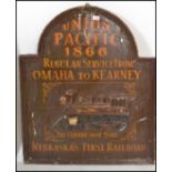 A 20th century wooden advertising sign being carved in relief and painted with notation and