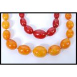 A vintage early 20th century hand knotted amber bead necklace having a barrel twist clasp. The