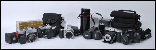 A collection of vintage cameras, lenses and accessories to include 35mm cameras such as Minolta,