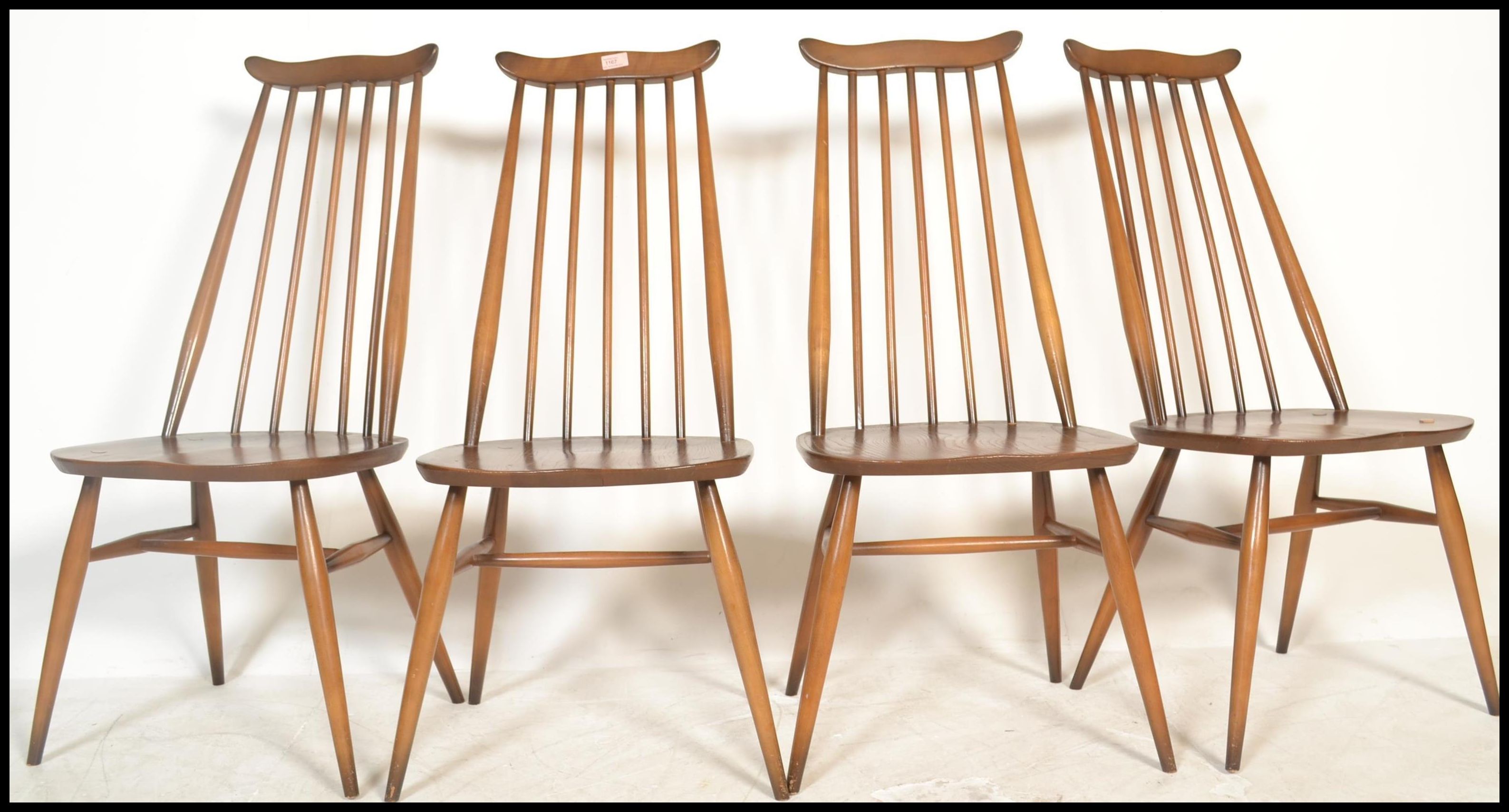 A set of four 20th century vintage Golden Dawn Ercol beech and elm stick back dining chairs,