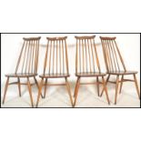 A set of four 20th century vintage Golden Dawn Ercol beech and elm stick back dining chairs,