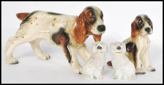 A pair of 19th Century Staffordshire ceramic dog figurines modelled as poodles together with a
