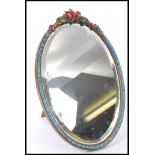 A 20th Century oval Barbola mirror having a carved wood floral frame with carved florals to the