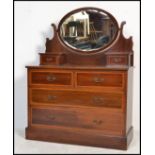 An early 20th century Edwardian mahogany inlaid dressing table chest of drawers having a oval mirror