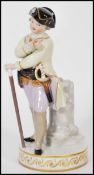 A Meissen porcelain figure modelled after Schonheit as a boy officer stood before marble pillar in
