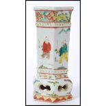 A 19th century Chinese pottery vase of hexagonal form having cartouche panels depicting typical