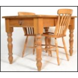 A 20th Century pine farmhouse dining table, pine top with single fitted drawer raised on shaped turn