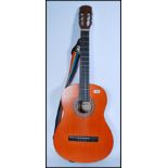 A vintage 20th century Epiphone Spanish acoustic guitar model C25 having shaped hollow body with