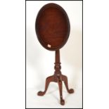 An antique style solid mahogany tilt top birdcage mechanism tripod wine table. The circular table
