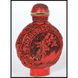 A 20th century Chinese Cinnabar Lacquer perfume bottle having floral decoration with Greek key