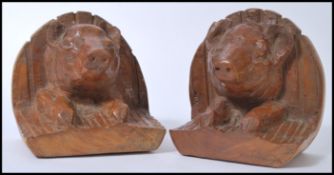 A pair of unusual hard carved wooden butchers shop display - ham fronts being in the form of pigs