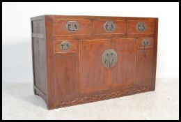 A 20th Century Chinese elm sideboard from the Shanxi Province having an arrangement of drawers and