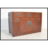 A 20th Century Chinese elm sideboard from the Shanxi Province having an arrangement of drawers and