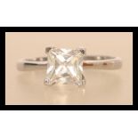 A hallmarked 9ct white gold engagement solitaire ring having a large square cut white stone.