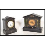 A 20th century slate mantel clock with with a central round enamelled face with roman numerals to